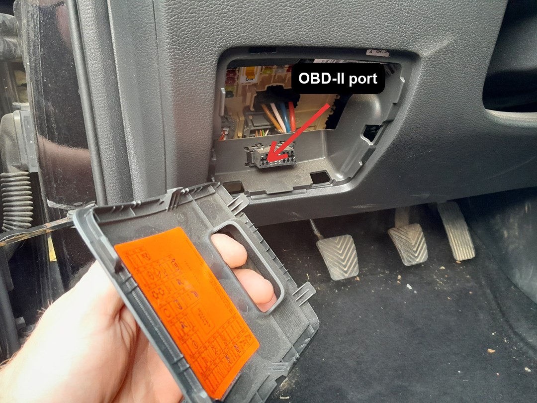 OBD-II port location on a Hyundai i30 (PD, 2017-present), driver's side lower dash behind the fuse-box cover above the pedals